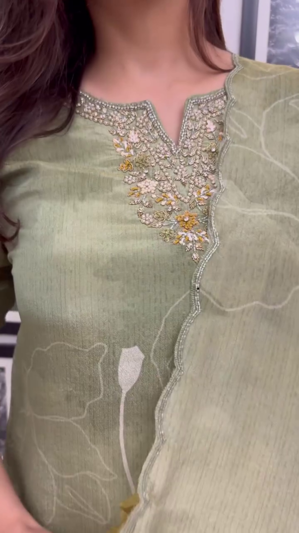 Light Olive Green Floral Printed Suit Set with Intricate Neck Embroidery, Pearl Detailing on Sleeves, Matching Dupatta, and Tapered Pants – A Perfect Blend of Subtle Glamour and Everyday Grace - Image 3