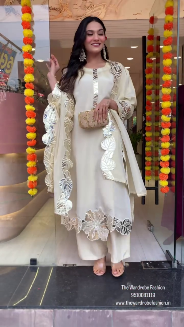 Cream Designer Cape Style Palazzo Set with Mirror Work Detailing and Floral Embroidery, Paired with a Coordinated Inner and Clutch – Perfect for Festive and Party Wear