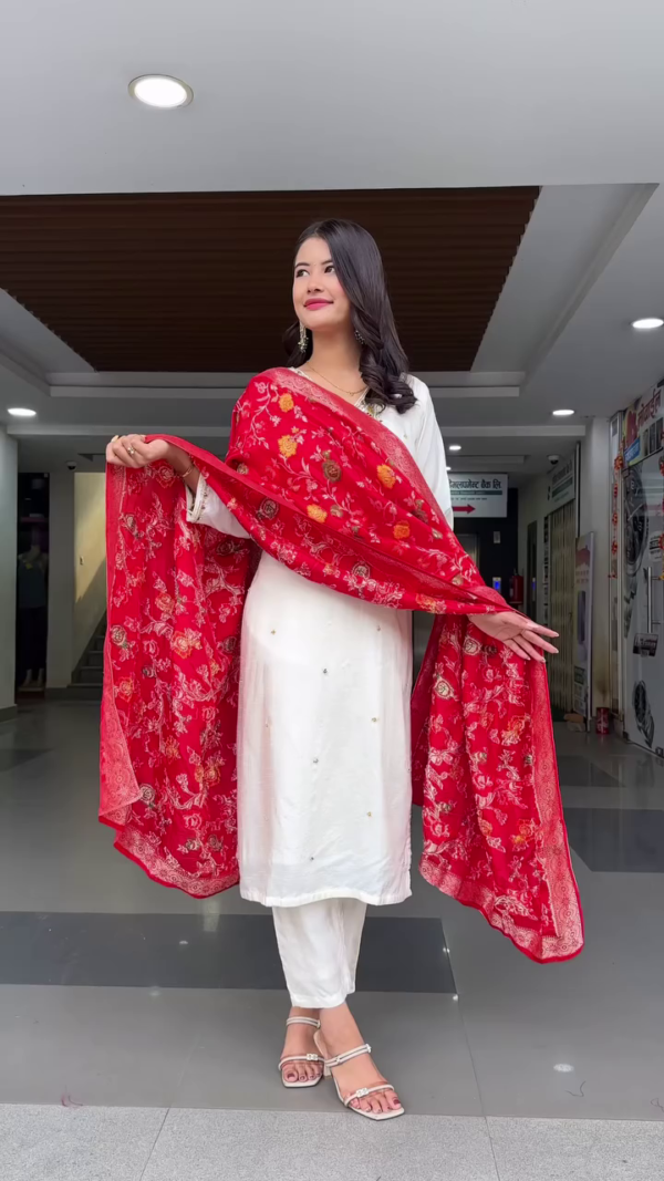 Graceful Off-White Straight-Cut Kurta Set with Delicate Floral Embroidery on the Neckline, Light Mirror Accents, and Paired with a Bold Red Floral Woven Dupatta – A Timeless Classic for Traditional Gatherings and Festive Wear
