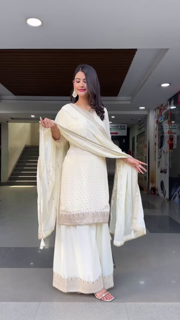 Off-White Traditional Ethnic Set Featuring Embroidered Straight Kurta with Intricate Golden Sequin and Thread Work, Paired with Flowy Sharara Pants and a Matching Soft Net Dupatta Adorned with Subtle Embellishments – Perfect for Festive Celebrations and Special Occasions
