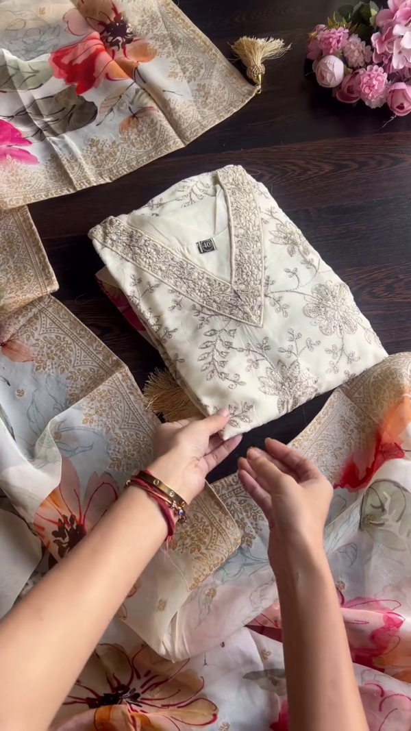 Elegant Off-White Silk Kurta Set Featuring Delicate Golden Thread and Sequin Embroidery, Paired with a Flowing Organza Dupatta Accentuated by Bold Multicolor Floral Prints – Perfect for Daytime Festivities and Graceful Gatherings