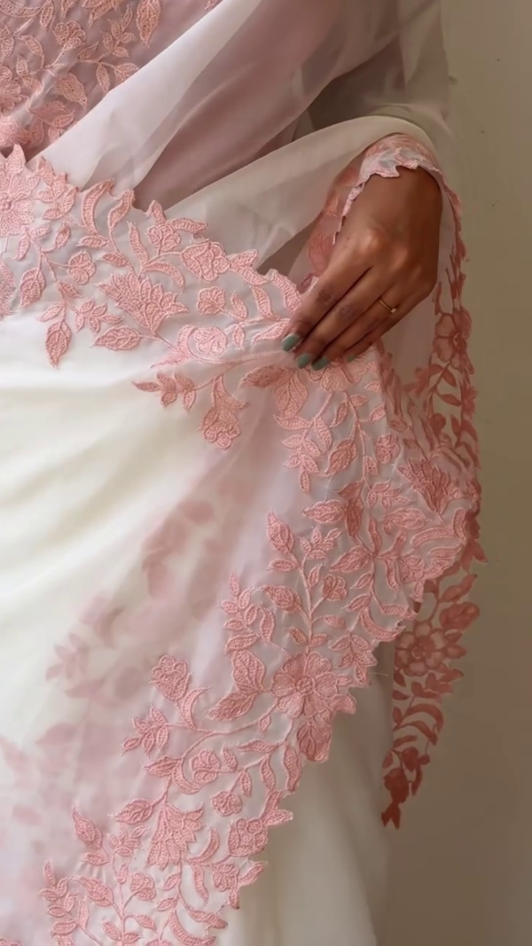 White Organza Saree with Intricate Baby Pink Floral Embroidery, Paired with Matching Pink Blouse and Pearl Accessories – Perfect for Festive, Wedding, or Traditional Occasions - Image 2