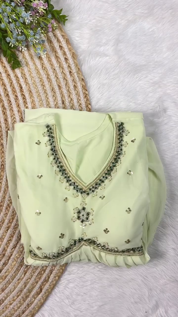 Pastel Green Embroidered Kurta Set Featuring Intricate Mirror Work and Pearl Detailing on the Neckline, Paired with a Soft Net Dupatta and Coordinated Bottoms – A Subtle and Elegant Ethnic Ensemble for Festive Wear, Day Events, or Celebrations