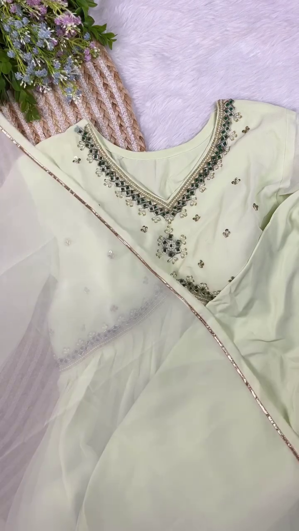 Pastel Green Embroidered Kurta Set Featuring Intricate Mirror Work and Pearl Detailing on the Neckline, Paired with a Soft Net Dupatta and Coordinated Bottoms – A Subtle and Elegant Ethnic Ensemble for Festive Wear, Day Events, or Celebrations - Image 2