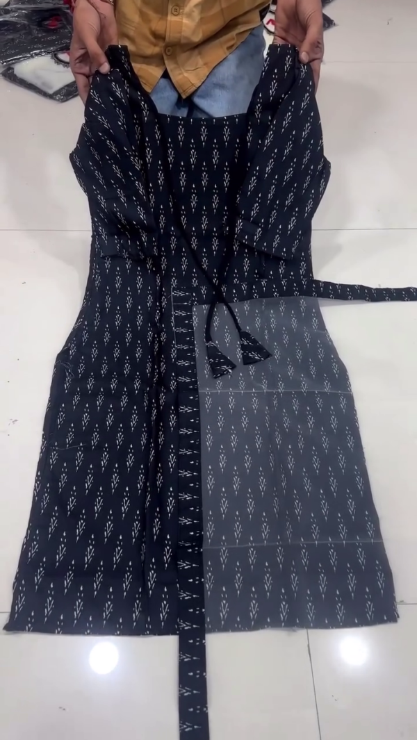 Black Printed Cotton Wrap Style Kurti with Ikat-Inspired Pattern, Front Tie-Up Tassel Detailing, and Side Belt for a Flattering Fit – Perfect for Casual and Ethnic Wear