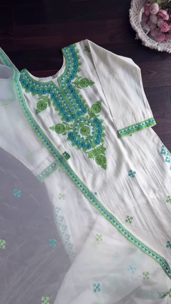 White Cotton Kurta Set with Green and Blue Thread Embroidery and Matching Sheer Dupatta Featuring Delicate Floral Motifs and Intricate Neck Detailing for a Graceful Ethnic Look