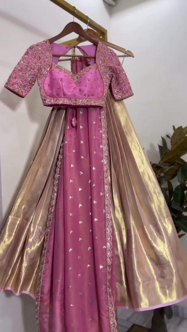 Pink Silk Lehenga Set Featuring Heavily Embellished Sweetheart Neck Blouse with Intricate Sequin Work, Paired with Matching Embroidered Skirt and Contrasting Gold Tissue Dupatta – A Perfect Blend of Traditional Craftsmanship and Festive Glamour