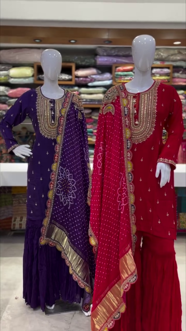 Regal Dual Sharara Suit Set Featuring Rich Purple and Vibrant Red Variants, Both Adorned with Intricate Golden Embroidery on Neckline and Sleeves, Paired with Flowy Tiered Shararas and Traditional Bandhej-Inspired Dupattas Accentuated with Gota Patti Borders and Festive Motifs – A Perfect Blend of Heritage Craft and Celebration Charm