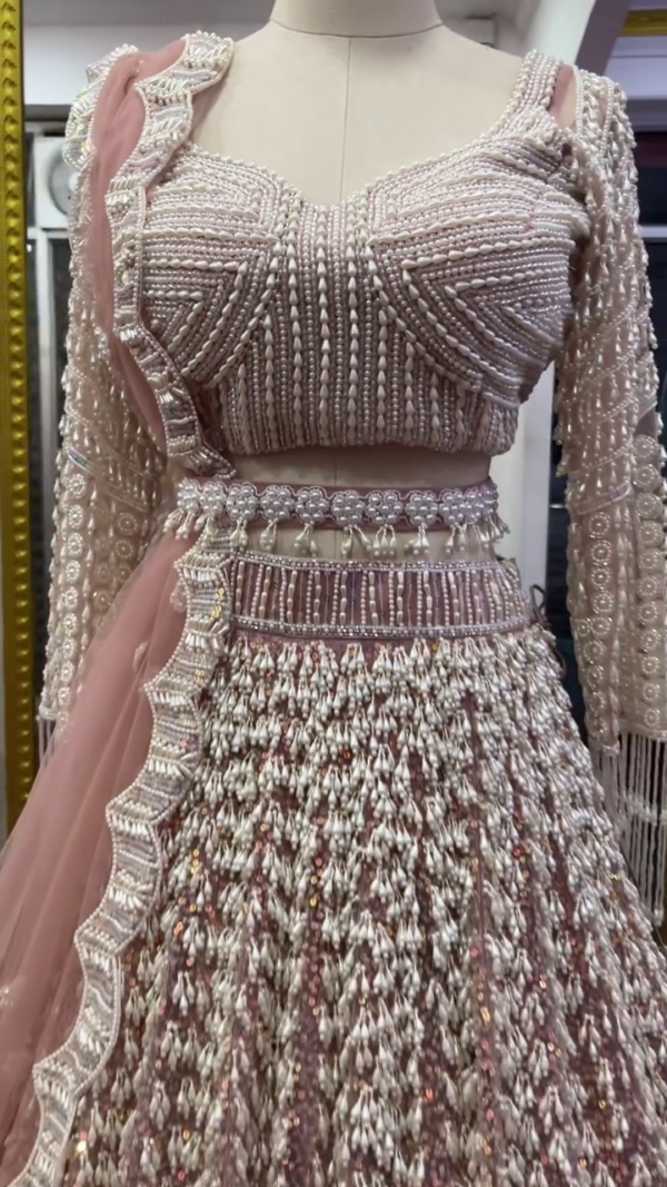 Luxurious Dusty Rose Pink Heavily Embellished Bridal Lehenga Choli Set Featuring Intricate Silver Zari and Sequin Embroidery, Full-Sleeve Pearl-Studded Blouse, and Scallop-Edged Net Dupatta – A Grand Ensemble for Weddings and Regal Celebrations - Image 2