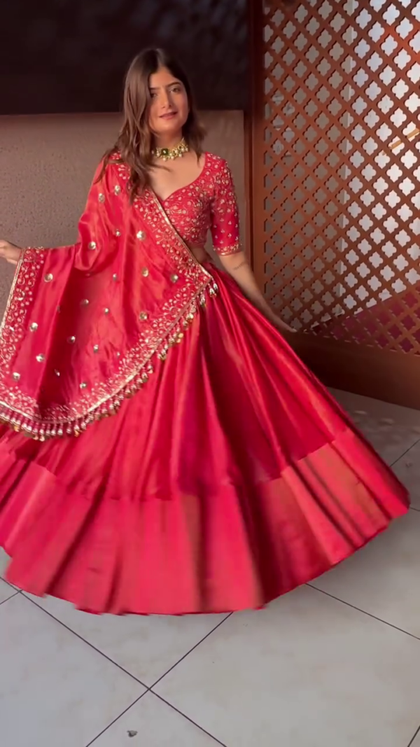 Radiant Red Silk Lehenga Choli Set Featuring Intricately Embroidered V-Neck Blouse, Mirror Work Dupatta with Detailed Border, and Flared Skirt – A Stunning Traditional Ensemble for Festive and Wedding Occasions