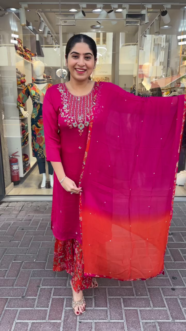 Vibrant Magenta and Red Ethnic Suit Set Featuring Intricately Embroidered Neckline, Printed Floral Sharara Bottom, and Dual-Tone Ombre Dupatta Accented with Subtle Sparkle Detailing – A Perfect Blend of Traditional Charm and Contemporary Style for Festive Celebrations and Cultural Events - Image 2
