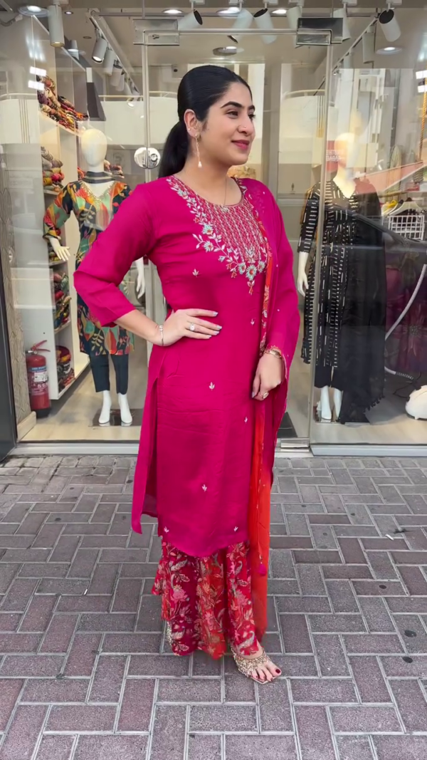 Vibrant Magenta and Red Ethnic Suit Set Featuring Intricately Embroidered Neckline, Printed Floral Sharara Bottom, and Dual-Tone Ombre Dupatta Accented with Subtle Sparkle Detailing – A Perfect Blend of Traditional Charm and Contemporary Style for Festive Celebrations and Cultural Events