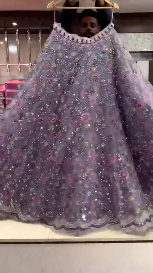 Lavender Purple Net Embroidered Lehenga Choli with Multicolor Sequin and Mirror Work, Intricate Floral Thread Embellishments, Stone-Fringed Dupatta and Scalloped Hemline – Perfect for Weddings, Sangeet, and Festive Occasions