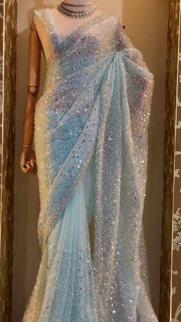 Ice Blue Designer Net Saree with Heavy Sequin and Stone Embellishments, Intricate Lace Border, and Matching Blouse – Perfect for Weddings, Receptions, and Grand Celebrations