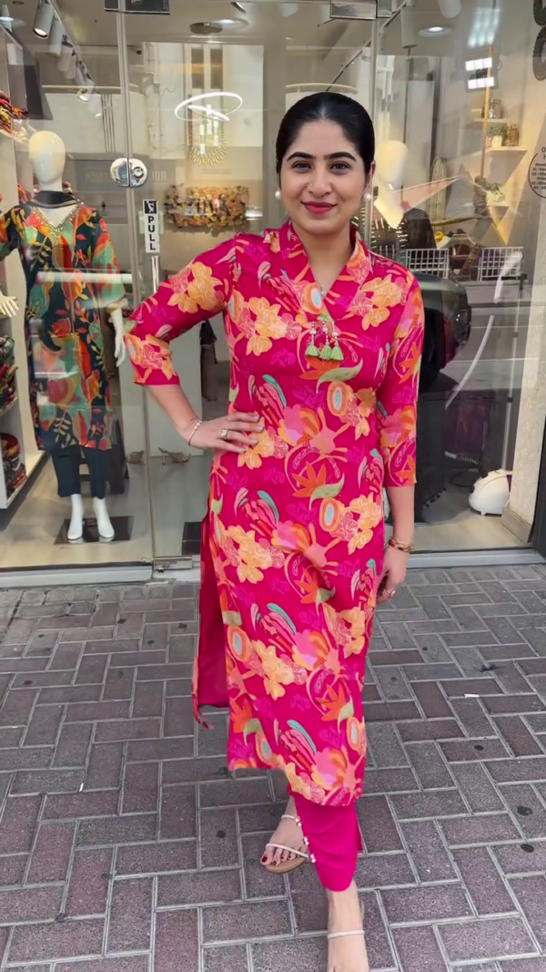 Bold and Vibrant Pink Straight-Cut Kurta Set Adorned with Striking Multicolor Tropical Floral Prints, Mandarin Collar with Tassel Detailing, and Paired with Solid Tapered Pants – A Perfect Fusion of Contemporary Flair and Ethnic Comfort for Casual Outings and Day Events