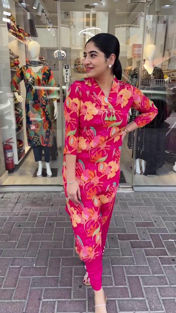 Bold and Vibrant Pink Straight-Cut Kurta Set Adorned with Striking Multicolor Tropical Floral Prints, Mandarin Collar with Tassel Detailing, and Paired with Solid Tapered Pants – A Perfect Fusion of Contemporary Flair and Ethnic Comfort for Casual Outings and Day Events - Image 2