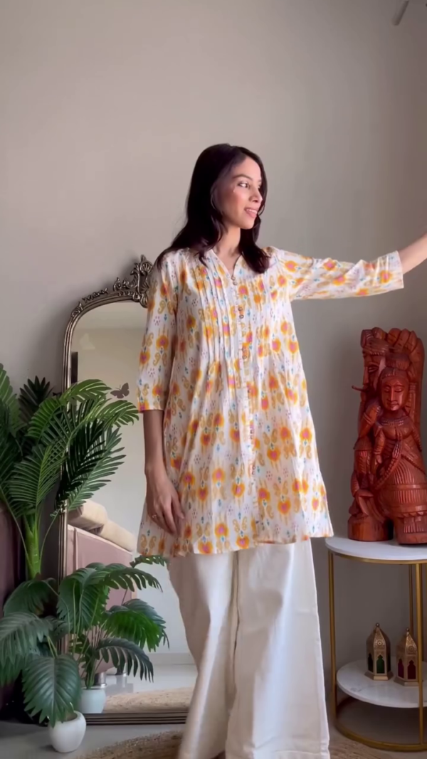 Lightweight Summer Multi-Shade Cotton Kurta Set Featuring Breezy Short Kurtis with Delicate Pintuck and Button Details, All-Over Floral Prints in Soft Yellow and Cool Teal Hues, Paired with Flowy White Palazzos – Perfect for Effortless Everyday Elegance and Warm-Weather Comfort