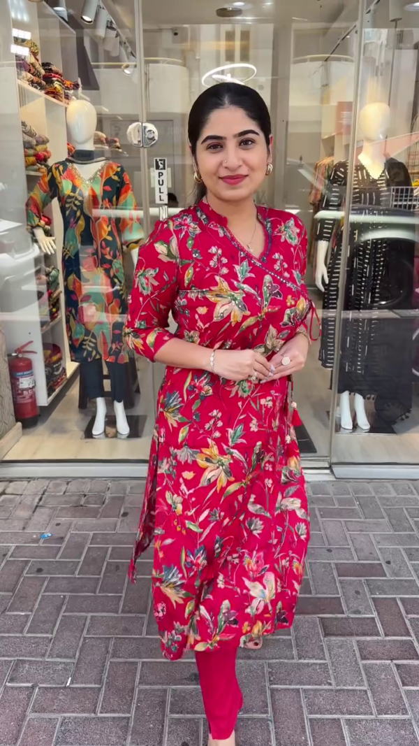 Chic Red Floral Printed Wrap-Style Kurta Set Featuring Overlapping V-Neckline with Tassel Tie Detailing, 3/4 Sleeves, and Coordinated Solid Pants – A Stylish and Comfortable Choice for Everyday Wear, Festive Gatherings, and Casual Outings with a Contemporary Ethnic Touch