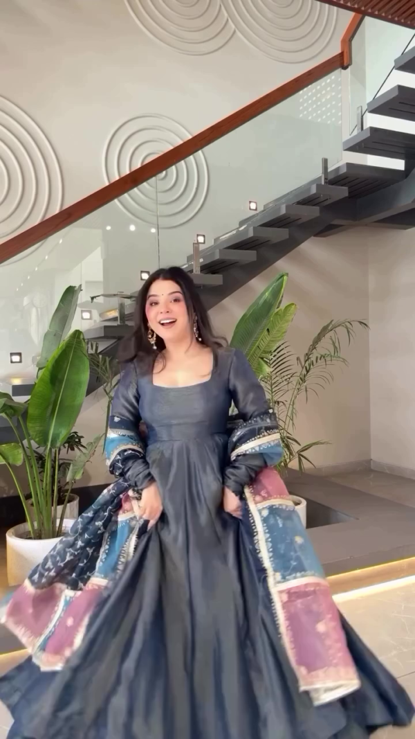 Gracefully Twirling in a Beautiful Navy Blue Traditional Dress with Colorful Printed Sleeves, Radiating Elegance and Joy in a Modern Minimalistic Interior Setting