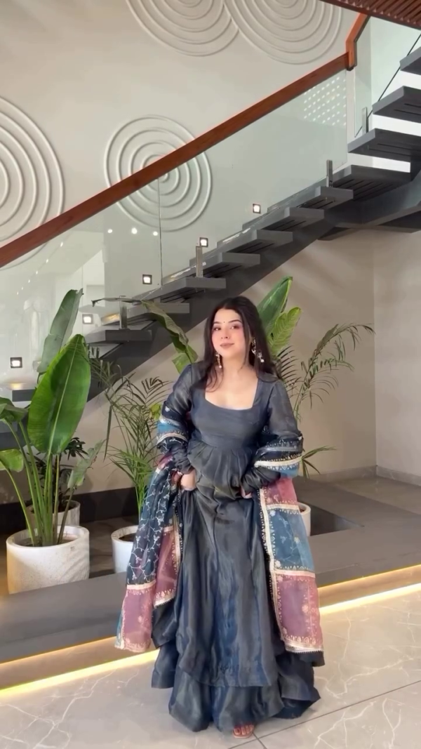 Gracefully Twirling in a Beautiful Navy Blue Traditional Dress with Colorful Printed Sleeves, Radiating Elegance and Joy in a Modern Minimalistic Interior Setting - Image 2