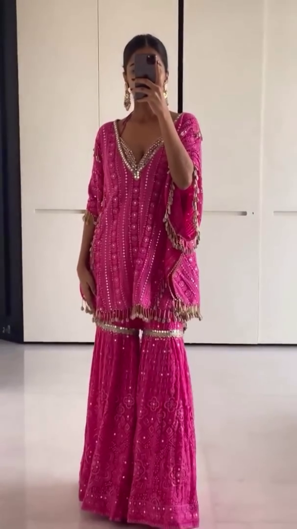 Striking in a Vibrant Pink Traditional Outfit with Intricate Embroidery and Tassel Detailing, Paired with Matching Embellished Flared Pants for a Modern Ethnic Look