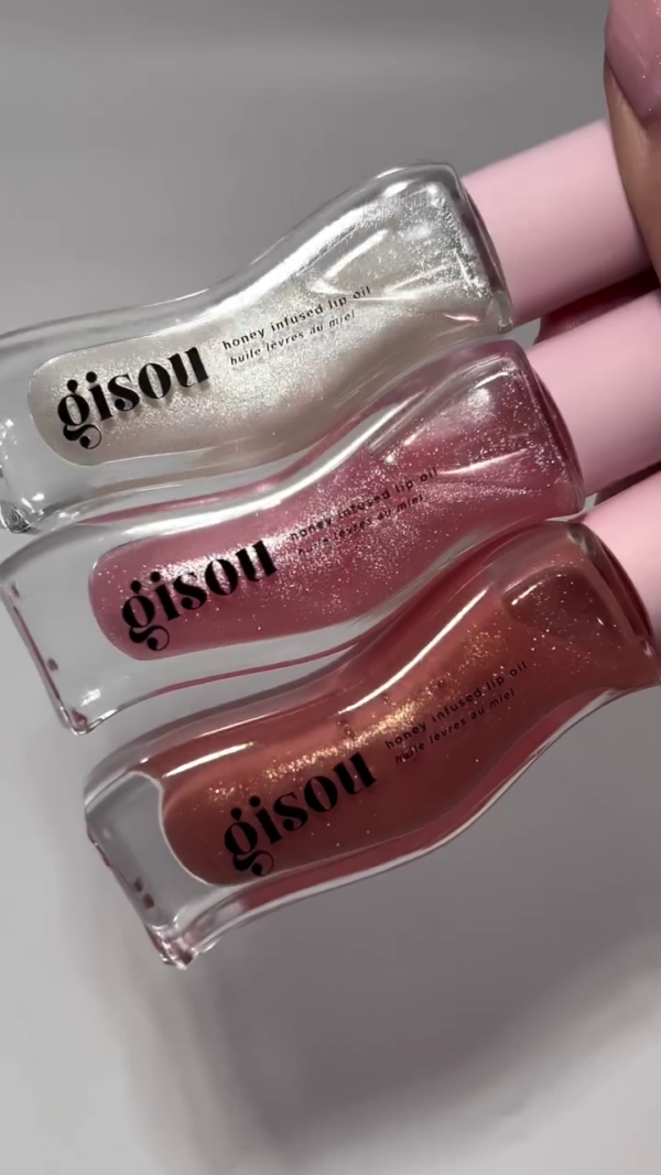 A collection of honey-infused lip oils in three beautiful shades—clear, soft pink, and a shimmering coral. Perfect for adding moisture, shine, and a subtle hint of color to your lips.