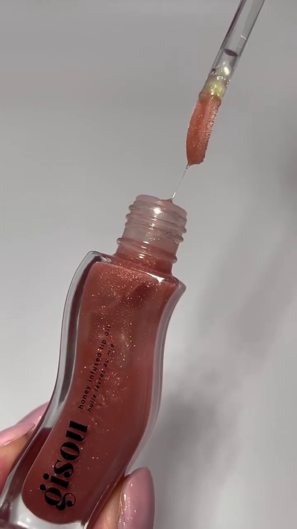 A collection of honey-infused lip oils in three beautiful shades—clear, soft pink, and a shimmering coral. Perfect for adding moisture, shine, and a subtle hint of color to your lips. - Image 2