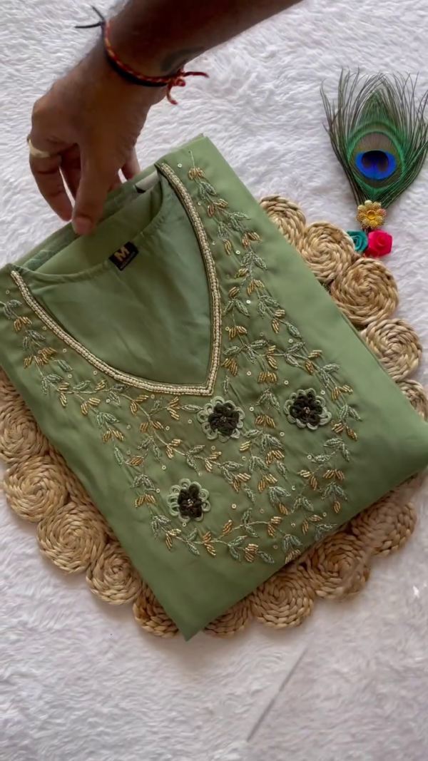 Pastel Sage Green Straight-Cut Kurta Set with Delicate Embroidered Neckline – Paired with a Flowing Organza Dupatta Featuring Soft Multicolor Floral Motifs – A Breezy Blend of Subtle Elegance & Everyday Comfort.