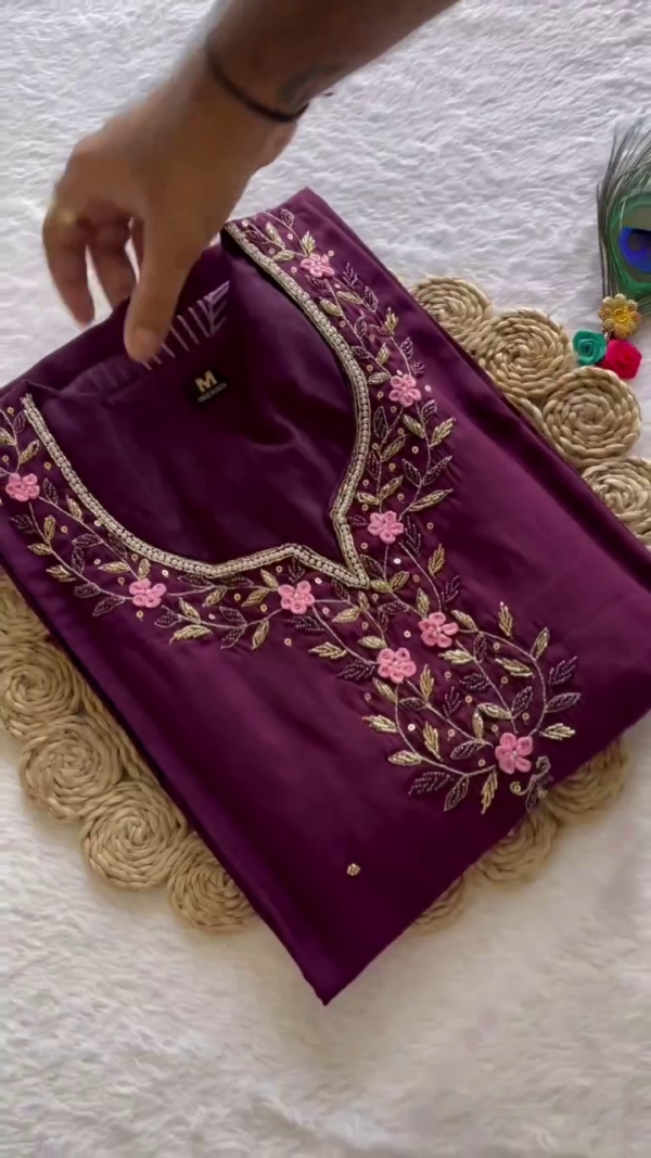 Graceful Purple Suit Set featuring intricate floral embroidery on the neckline paired with a sheer printed dupatta highlighted by white leaf motifs and a contrasting border.