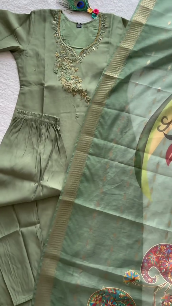 A graceful sage green ethnic set featuring a rich satin finish with golden embroidery on the neckline. Paired with a coordinating dupatta that showcases delicate motifs and a shimmering border — ideal for festive gatherings or elegant day functions. - Image 2