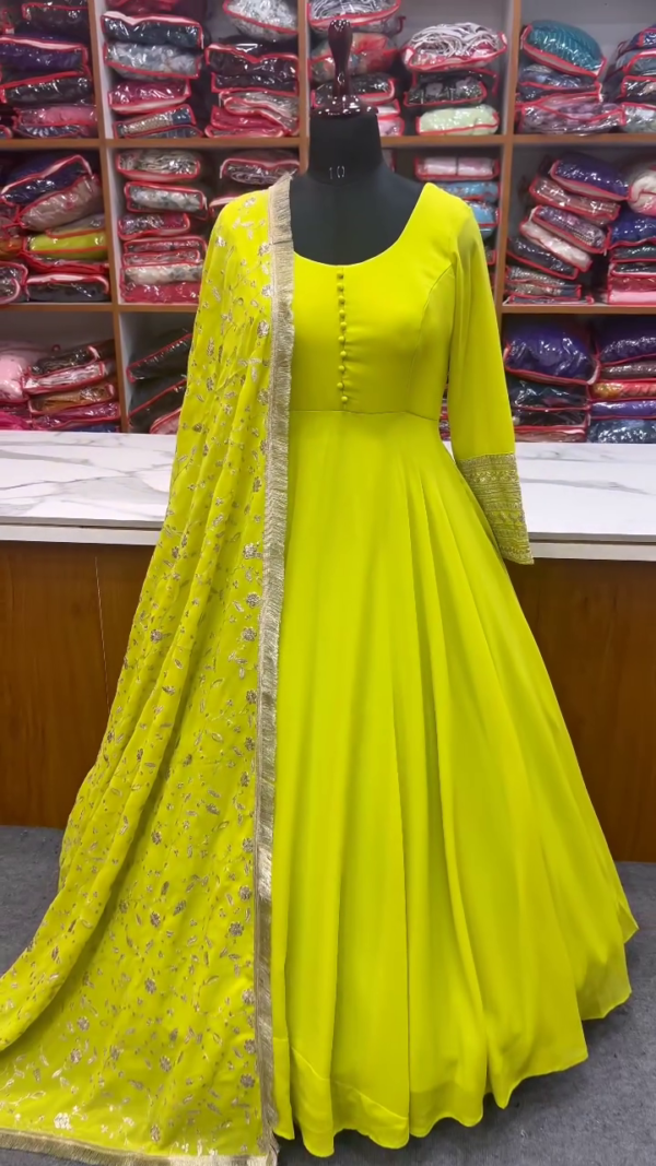 Luminous Lime Yellow Anarkali Gown with Front Button Detailing, Embroidered Golden Border Sleeves, and Sheer Net Dupatta Embellished with Intricate Floral Sequin Work – A Radiant and Elegant Ensemble for Haldi Ceremonies, Festive Functions, and Daytime Celebrations