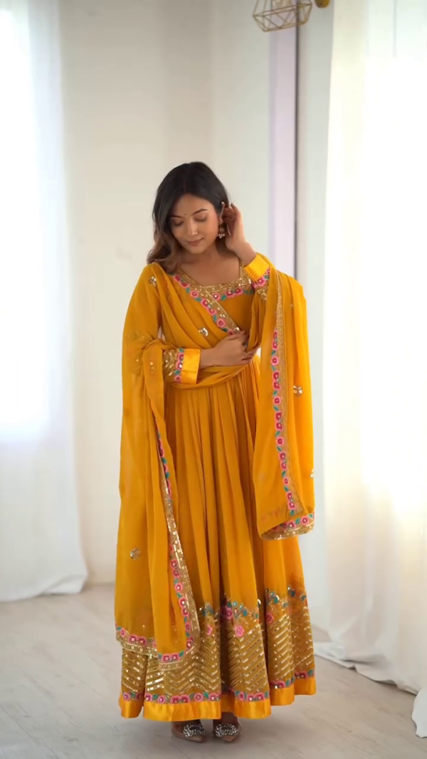 Vibrant Yellow Anarkali Suit with Floral Embroidery and Sequined Detailing – Paired with a Sheer Dupatta for Festive and Traditional Celebrations